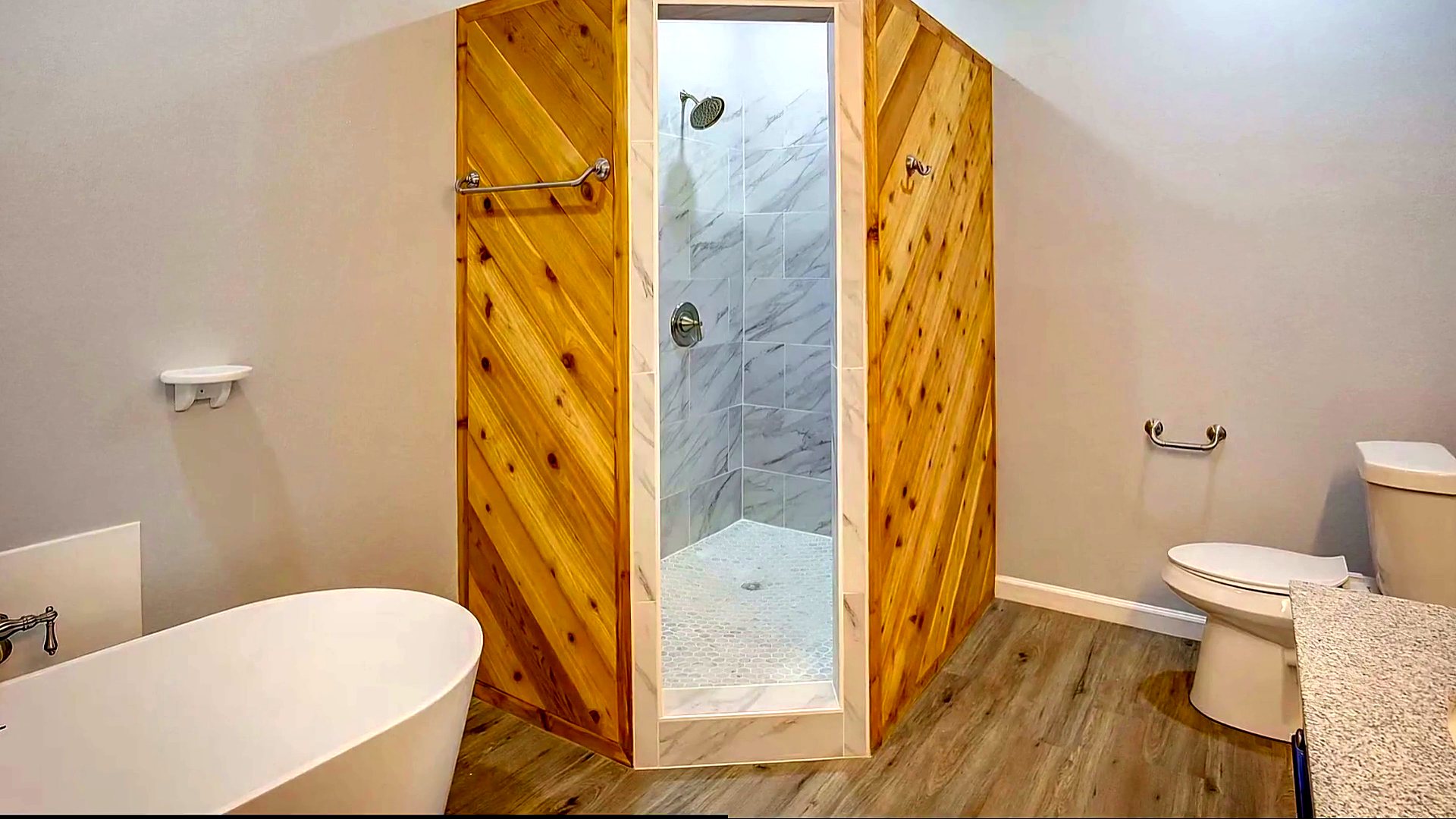 Bathroom with a cedar barn door and walk-in shower