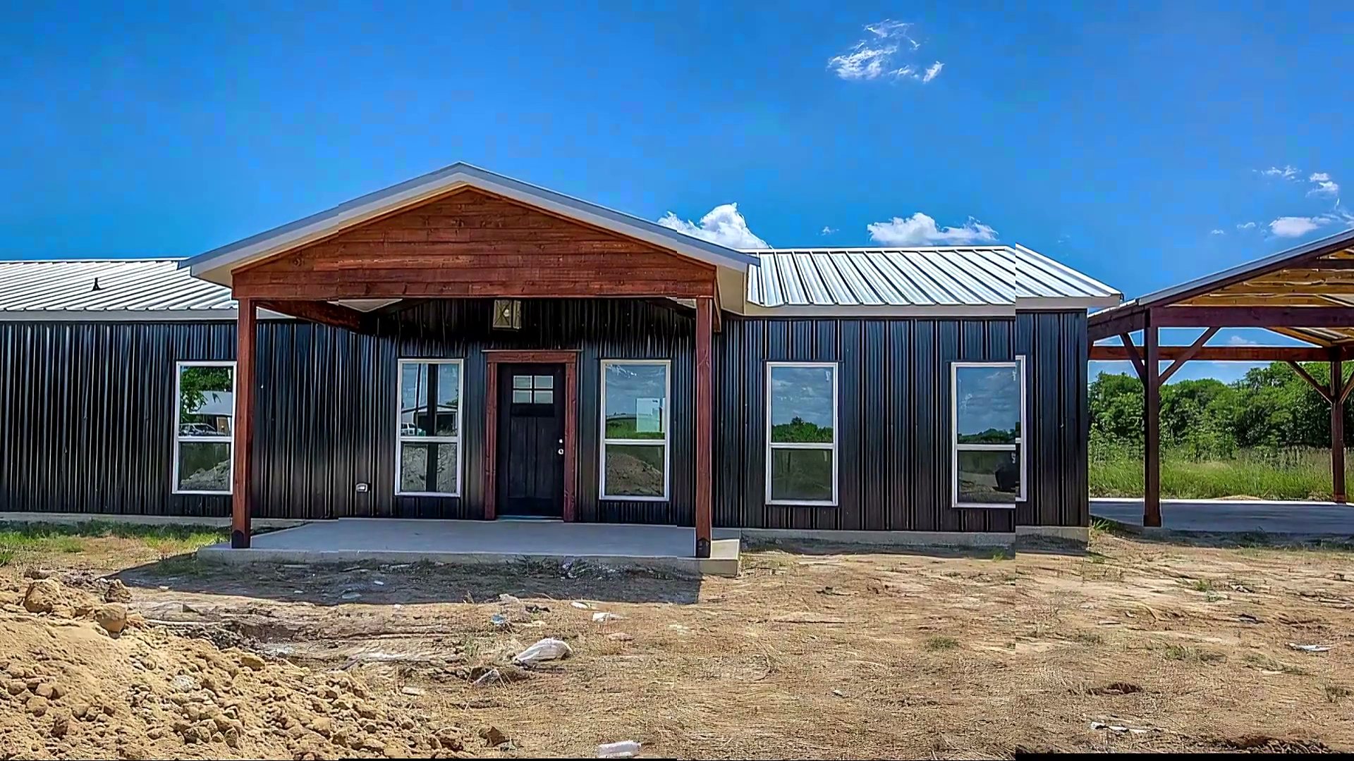Black steel-sided barndominium we built